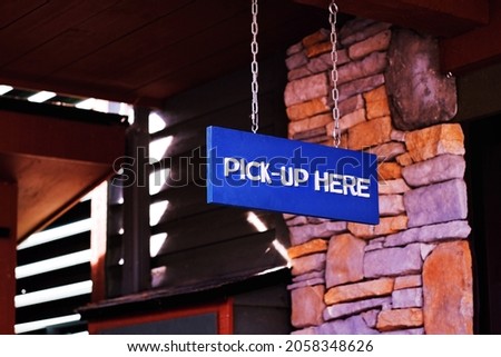 Blue pick up here sign at shop