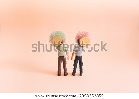 Two man with Christmas tree celebrate New year. Pink background and minimal holiday concept.