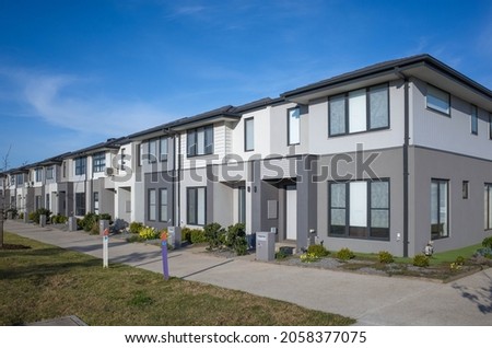 A row of modern residential townhomes or townhouses in Melbourne's suburb, VIC Australia. Concept of real estate development, the housing market, and homeownership.	 Royalty-Free Stock Photo #2058377075