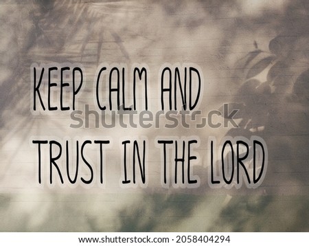 Short message saying keep calm and trust in the Lord. Tree shade on the wall.