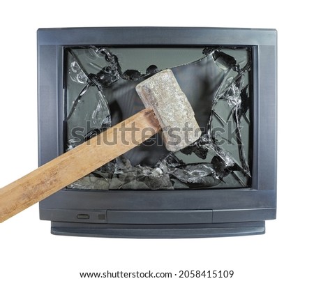 Smashed old kinescope television. Big sledgehammer smashes old TV. Broken monitor