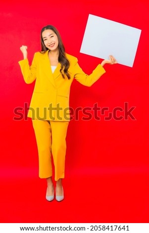 Portrait beautiful young business asian woman smile with empty white billboard for text
