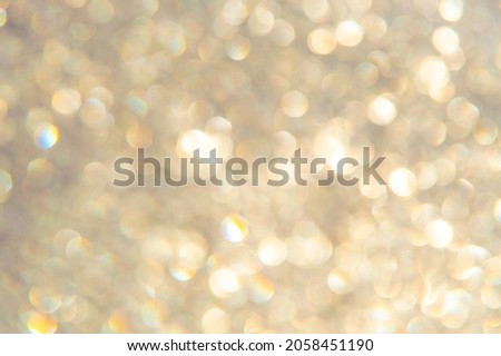 bright glitter background: bokeh effect from many colored lights on frozen glass, toning 
