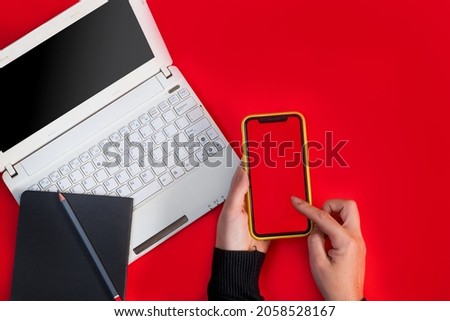 Laptop smartphone and tablet on a red background on the day of discounts. Black friday and cyber day concept.