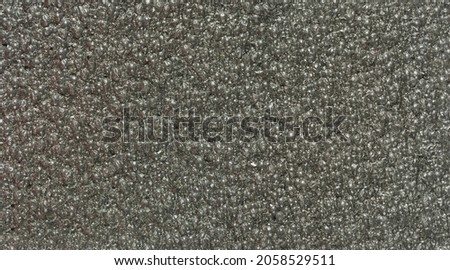 close up, background, texture, large long horizontal banner. surface structure black expanded polyethylene, EPE, padding cushioning material for packages. full depth of field. high resolution photo