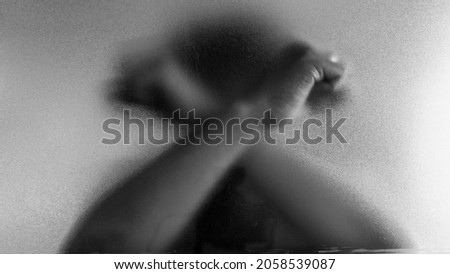 cross hand symbol. Shadow hands of the Man behind frosted blurred glass. Blurry hand abstraction. black and white halloween Royalty-Free Stock Photo #2058539087