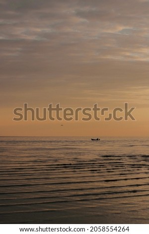 Boat in the sea during the summer sunset 