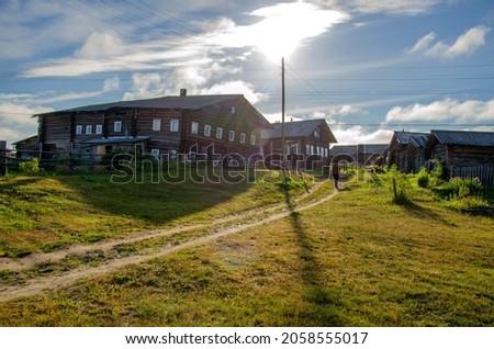 Summer in the Russian outback. Old wooden houses in the countryside. Rustic landscape.