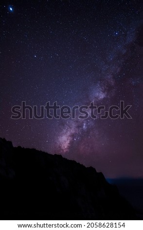 Milky way and pink light on the mountain colorful landscape at night