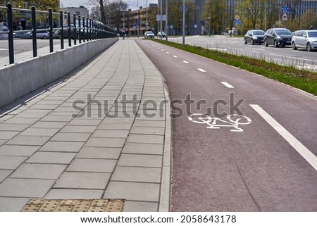 Pedestrian path with red bicycle lanes on the right side