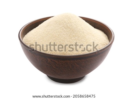 Bowl of uncooked organic semolina isolated on white Royalty-Free Stock Photo #2058658475