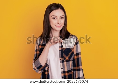 Photo of positive cheerful wealthy lady cash money pocket isolated yellow color background