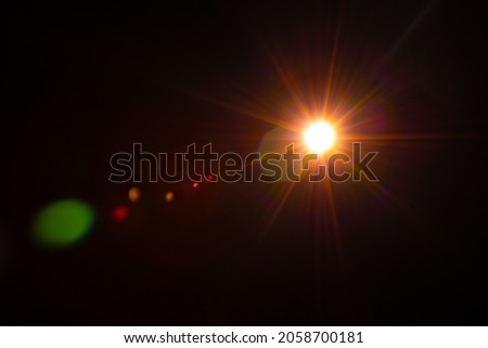 Sun flare on the black background Royalty-Free Stock Photo #2058700181