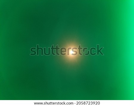 Abstract light pattern burst from glowing source of radiation and optics