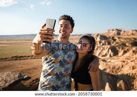 Young caucasian couple taking a selfie at Bardenas Reales, Navarra, Basque Country.