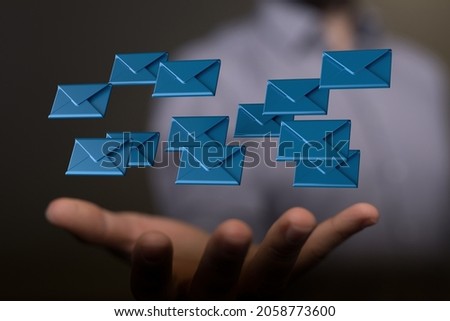 An abstract shot of male hands showing digital messages and emails symbols and icons in cyberspace