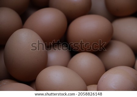 pile of chicken eggs in large quantities on a paper tray