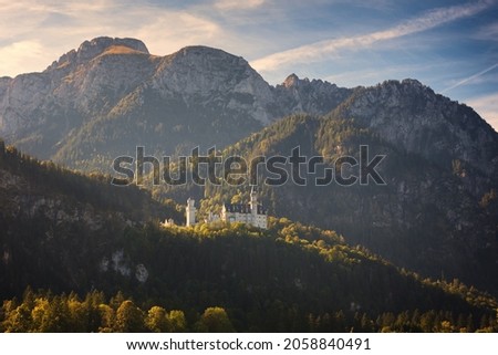 Picturesque landscape with Neuschwanstein Castle on beautiful Alp mountains background