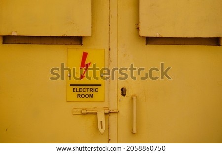  Steel yellow door of electric equipment room.                               