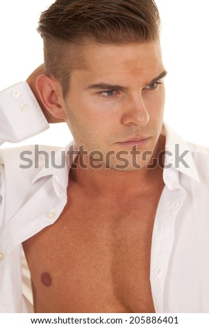 a man with his hand by his head with his white dress shirt unbuttoned.