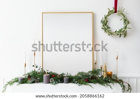 Festive golden photo frame against a white wall