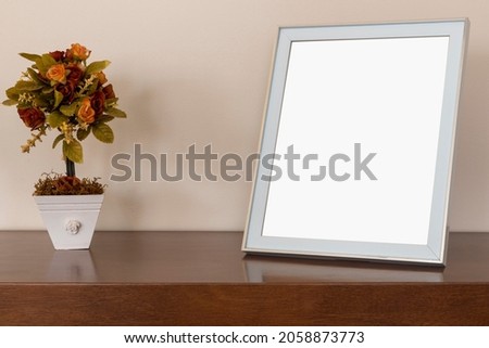 photo frames and flower vases on the table