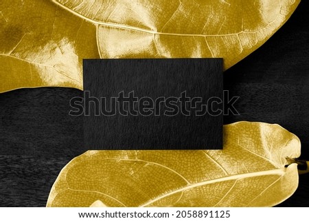 Blank birthday card on golden leaves