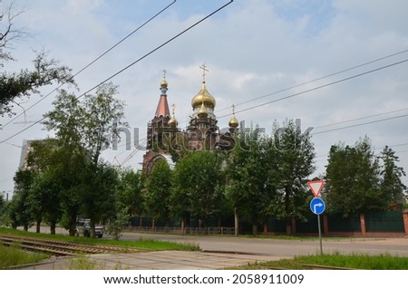 This picture shows a church with road, railway and wires