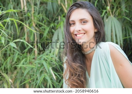 A beautiful shot of a caucasian female posing for a photo in a forest in Argentina
