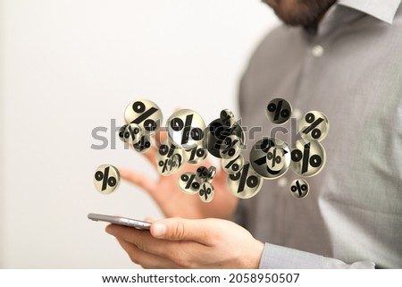 A conceptual wallpaper with floating percentage signs and a male with a smartphone 