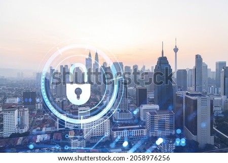 Padlock hologram on sunset panoramic cityscape of Kuala Lumpur, Malaysia, Asia. The concept of cyber security intelligence in KL. Multi exposure.