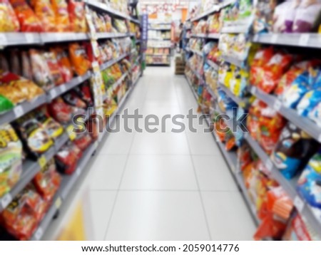 Abstract blurred grocery store interior background. Blur aisle of supermarket, grocery store or warehouse for backdrop and design element use. Defocused background with bokeh light.