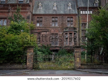 Carriage entrance to an old abandoned orphanage on a cold autumn morning  Royalty-Free Stock Photo #2059017602