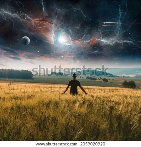 Young man standing in rural czech wheat field landscape with planet, fractal nebula, stars and cloud at sunset. Fantasy photo manipulation. Elements furnished by NASA, 3D rendering Royalty-Free Stock Photo #2059020920