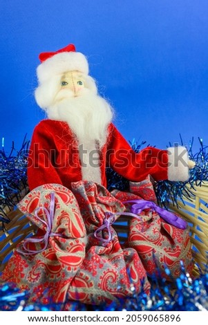 Toy Santa Claus goes to give gifts to children. Christmas and New Year concept.