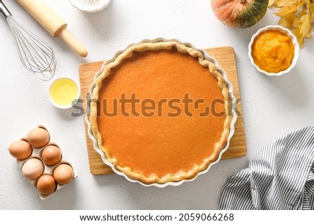 Process of making Pumpkin Pie for Thanksgiving Day on white background. Seasonal traditional autumn cake for home festive dinner. Top view. Royalty-Free Stock Photo #2059066268