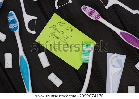 A note of dentist appointment and dental hygiene tools.