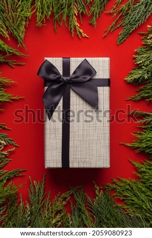 Merry Christmas and happy new year. Gift box on red background.
