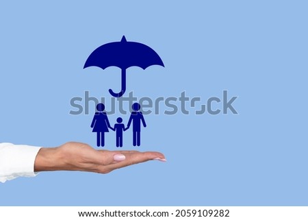 Umbrella over the concept of family for protection, safety, finance and insurance on a female palm. Copy space.  kids vaccine