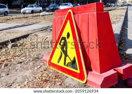 Road works traffic sign at the city street. Under construction road sign