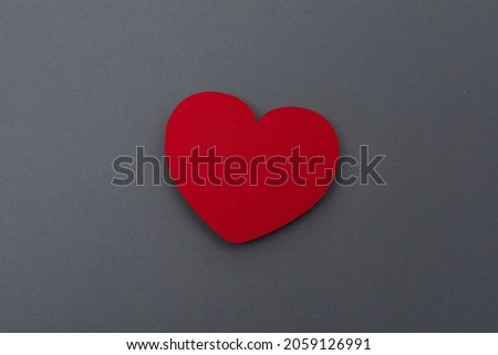 A red heart isolated on grey background- valentine concept