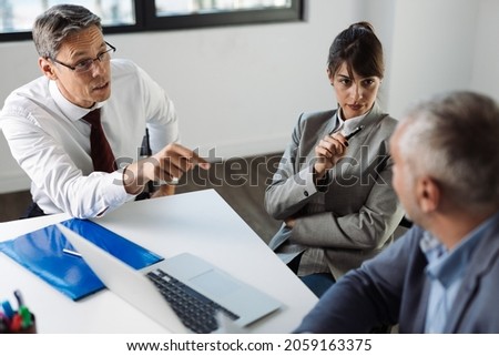 Business people talking to each other while having a business meeting in the office