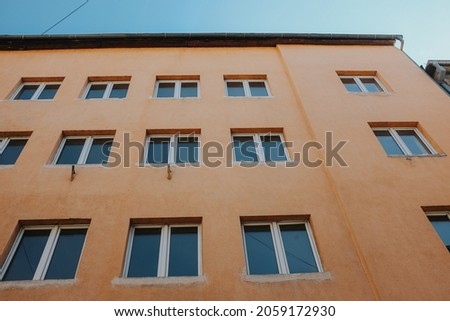 A low-angle shot of the facade and windows of a building