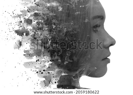 A black and white profile portrait of a thoughtful woman combined with black ink strokes and splashes. Paintography.