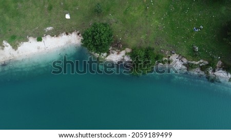 A bautiful shot of a lake near a green shore