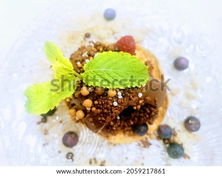 chocolate cake with blueberries with mint leaves