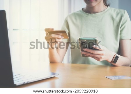 Woman enjoy with online shopping application and typing credit card for fill number to payment