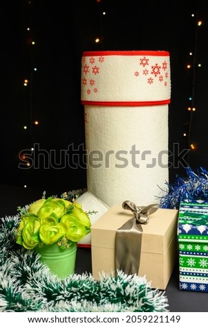 Gifts and flowers from Santa Claus. Christmas and New Year concept on black background.
