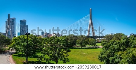 Paul Revere Landing Park green meadow landscape with the view of Zakim Bridge and downtown buildings in Boston