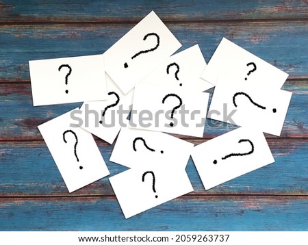Many cards with question mark on the blue board background